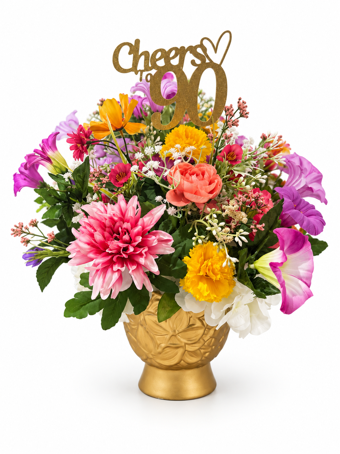 Colorful floral arrangement in a gold vase with a Cheers 90 topper against a white background